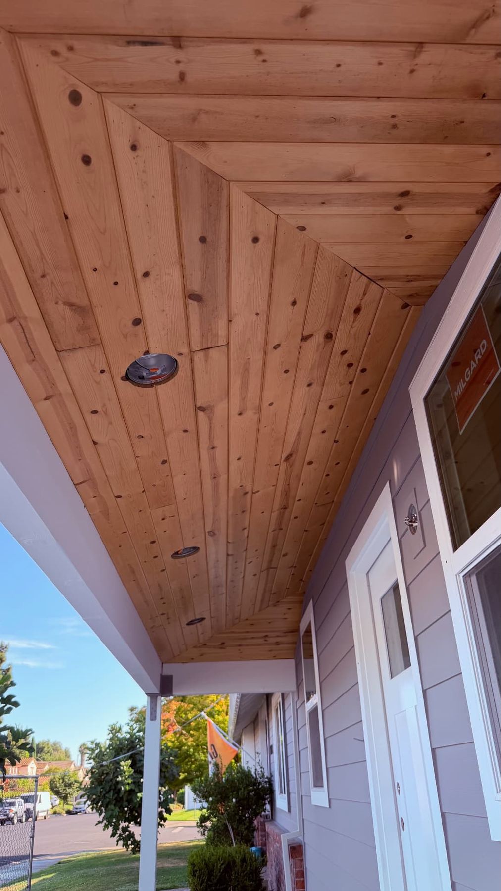 Tongue and groove cedar porch ceiling with mitered corners and recessed lighting on a Lane Built front porch