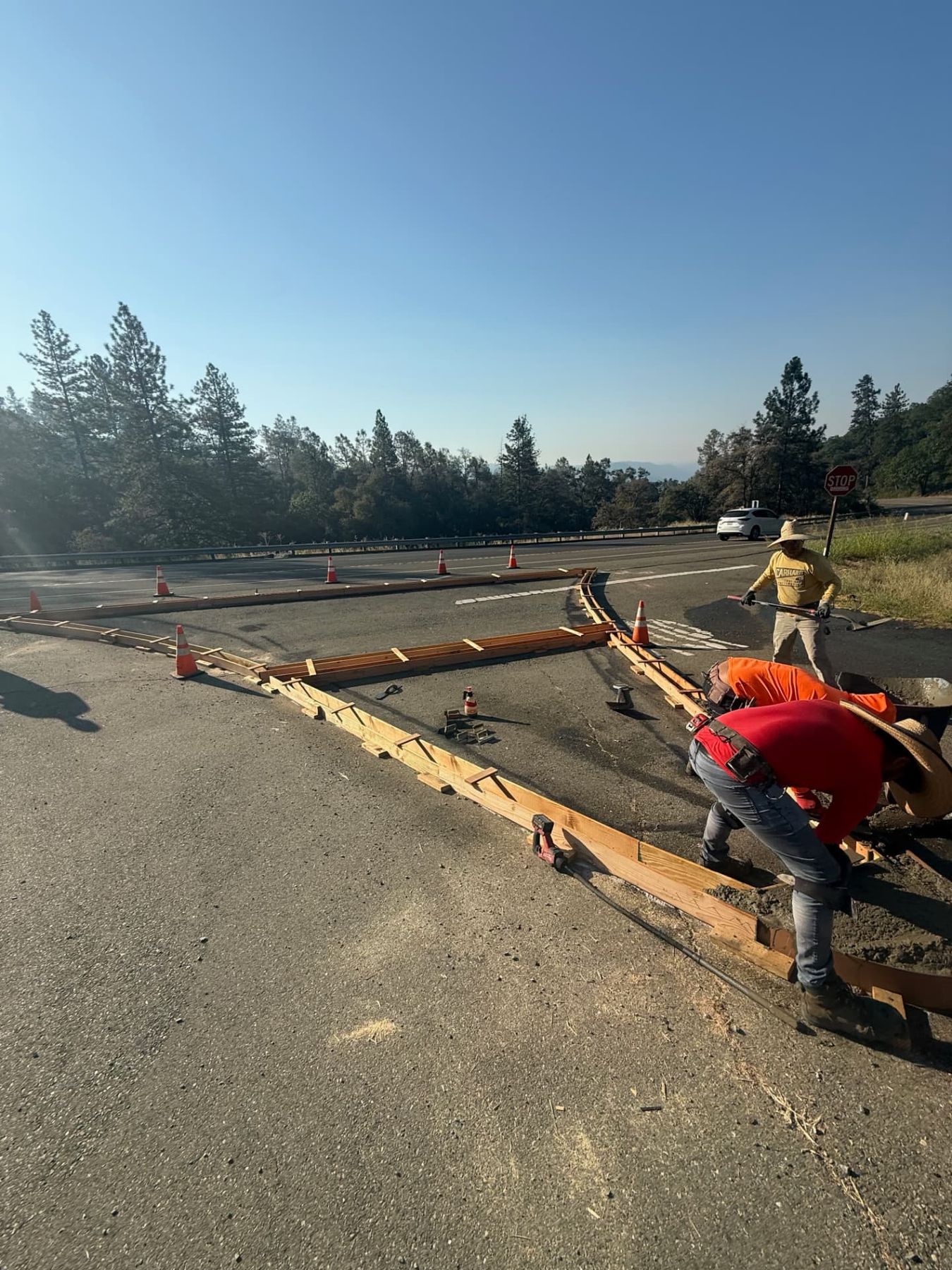 Lane Built crew setting curb forms for a concrete traffic island on a state highway intersection