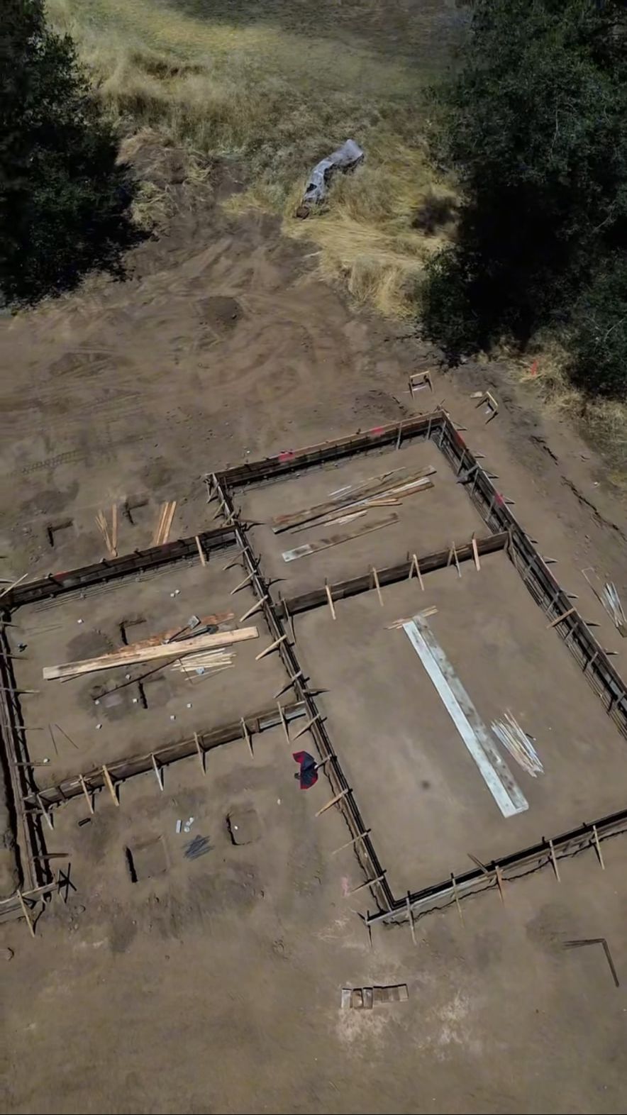 Aerial view of formed foundation walls staked and braced before the concrete pour