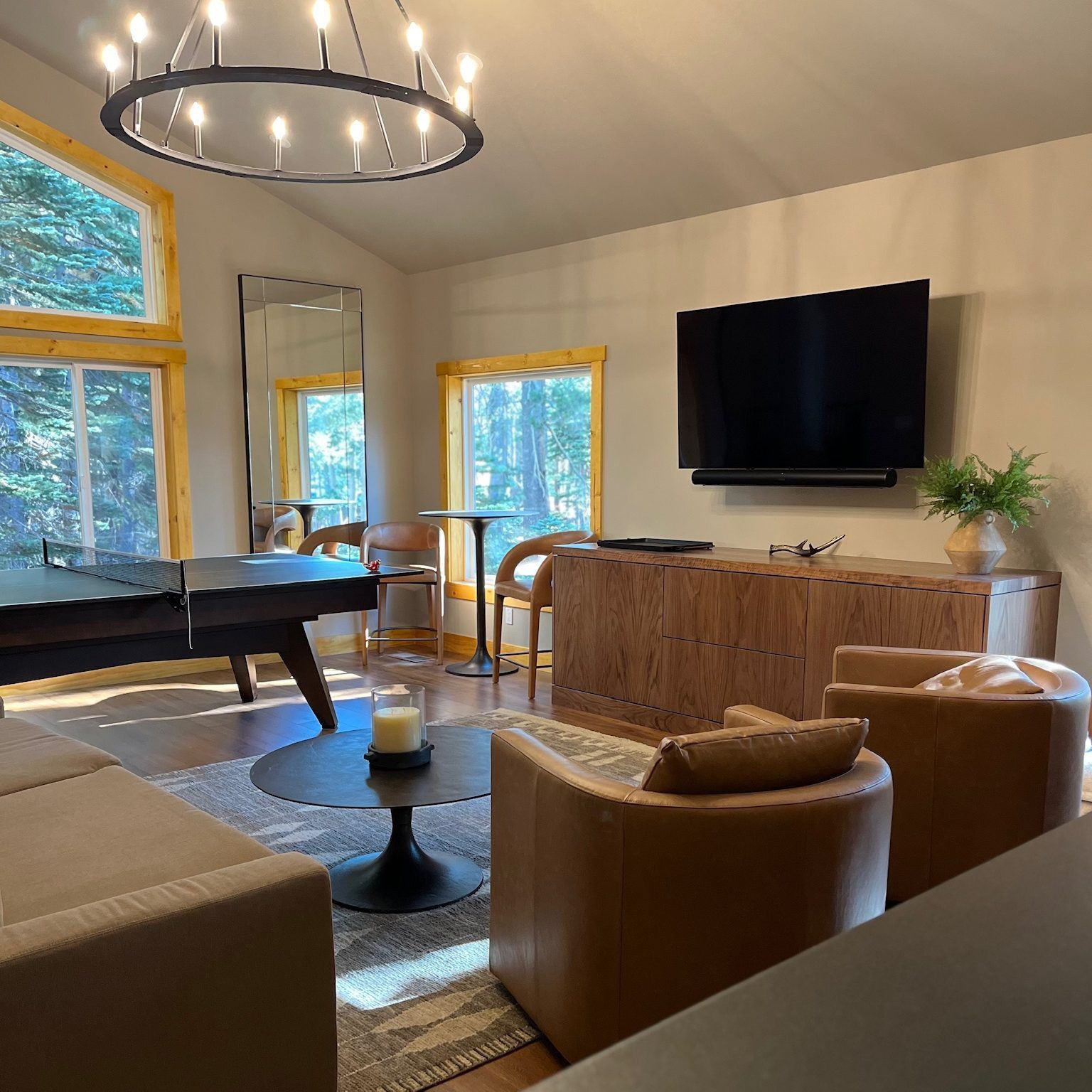 Vaulted great room with a ring chandelier and tall windows in a Lane Built home