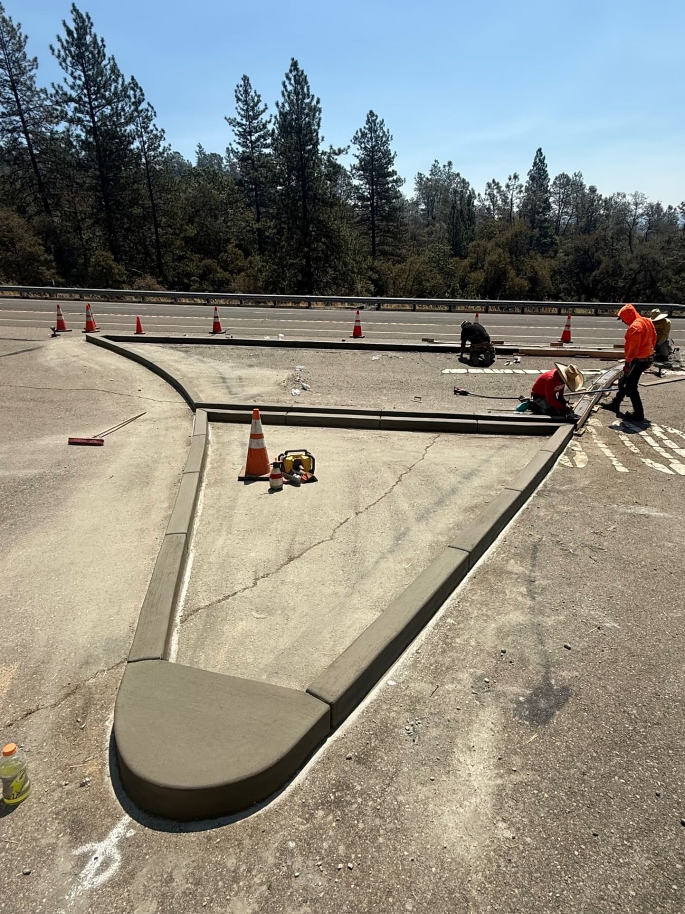 Finished poured concrete traffic islands and curb work at a highway intersection in the Sierra foothills