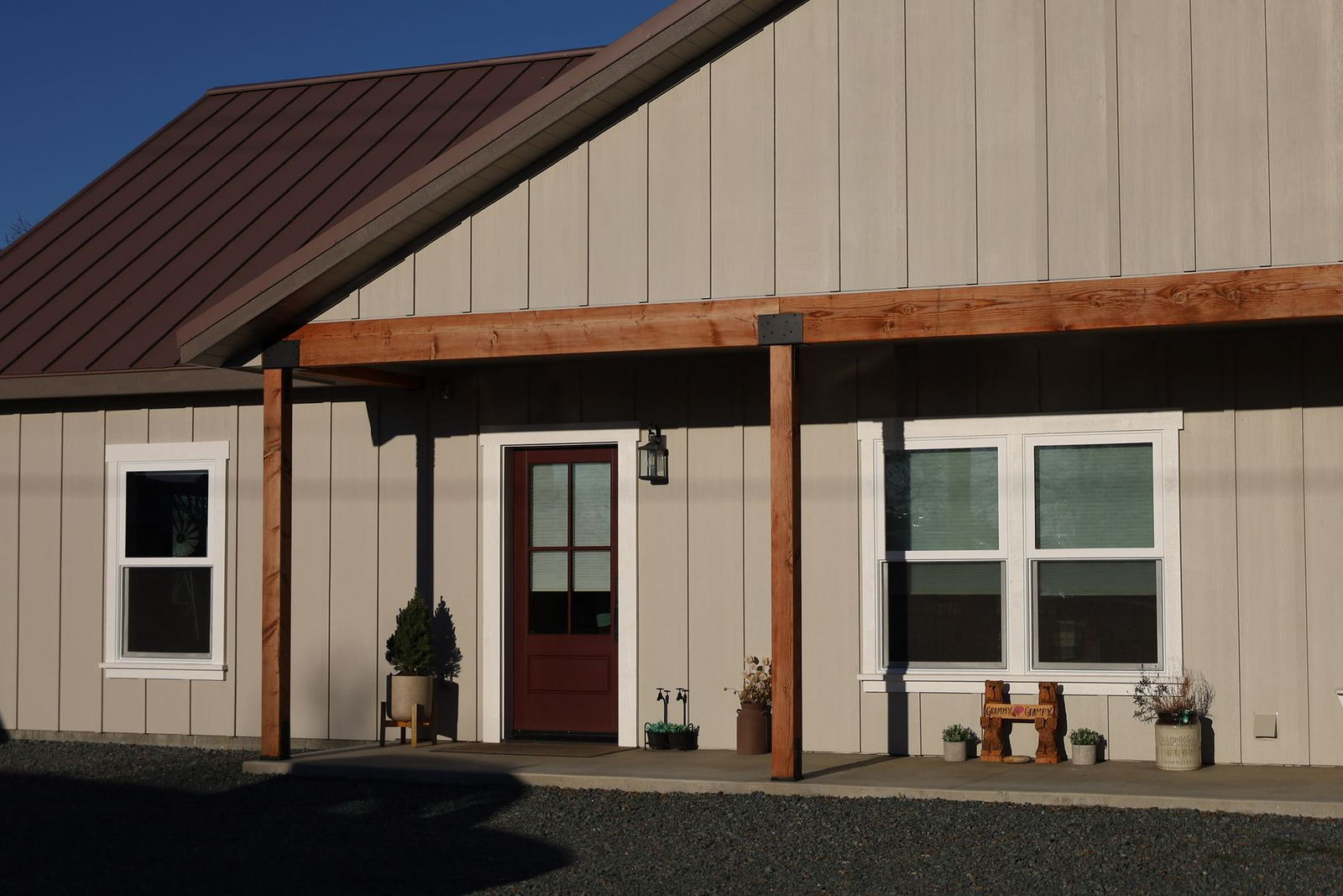 Board and batten siding with timber porch posts on a completed Lane Built home