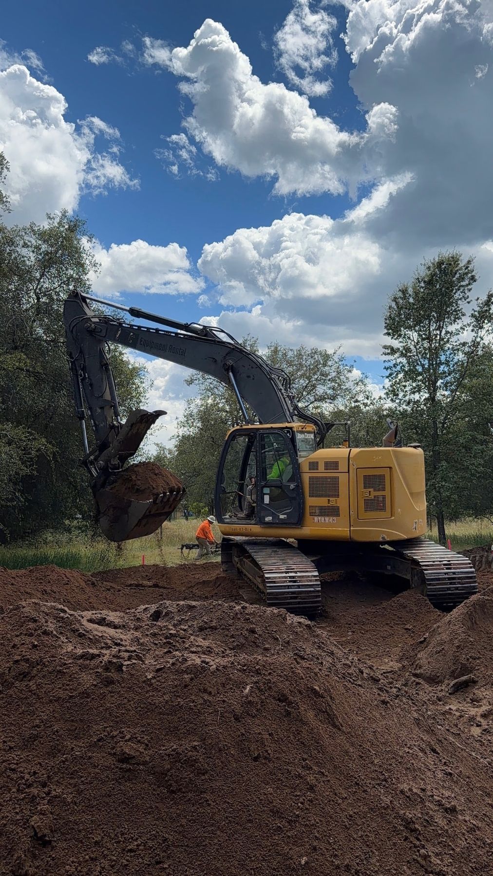 Lane Built excavator moving dirt during site grading for a Northern California custom home