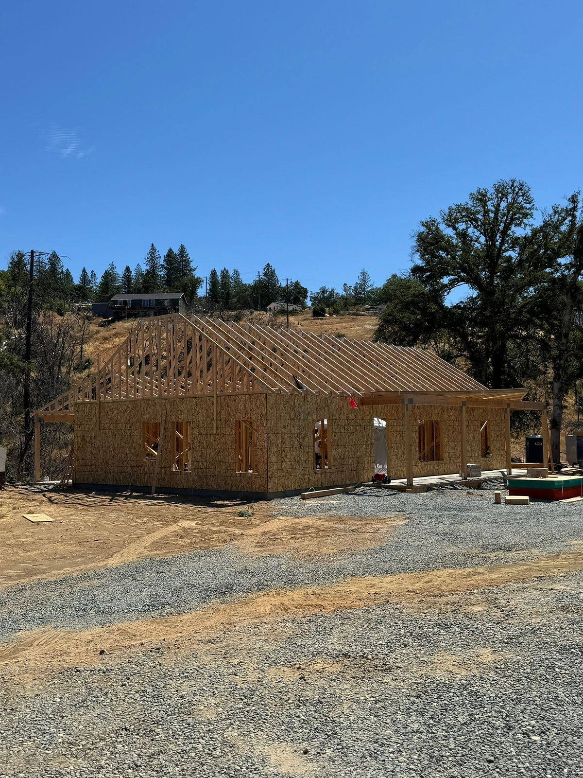 Custom home framed and sheathed under valley oaks on a Placer County lot