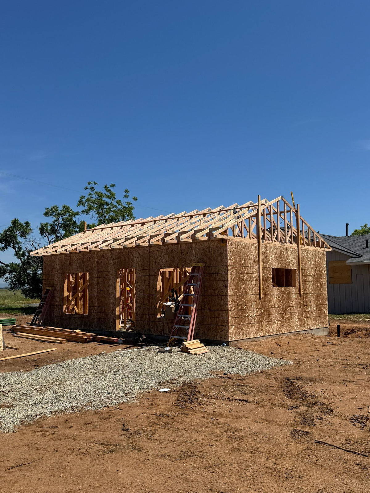 Detached garage under framing with trusses being set
