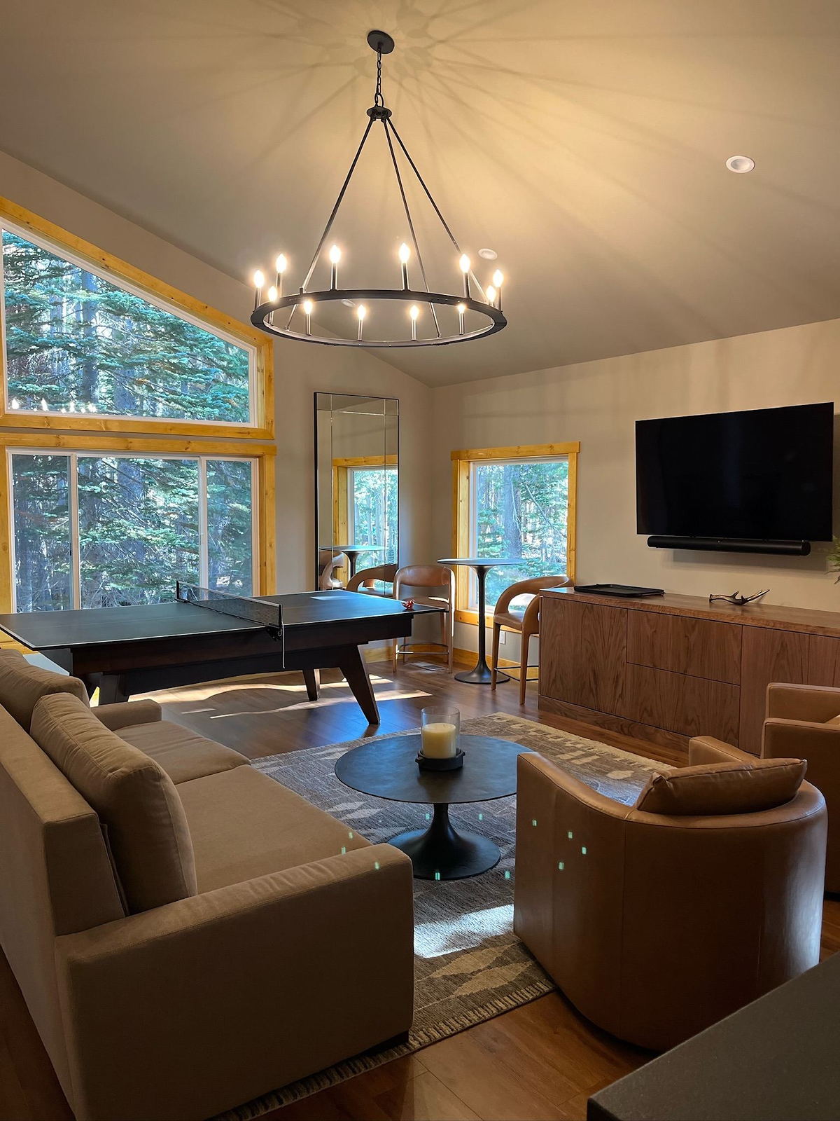 Vaulted living room with a ring chandelier and tall windows in a Lane Built home
