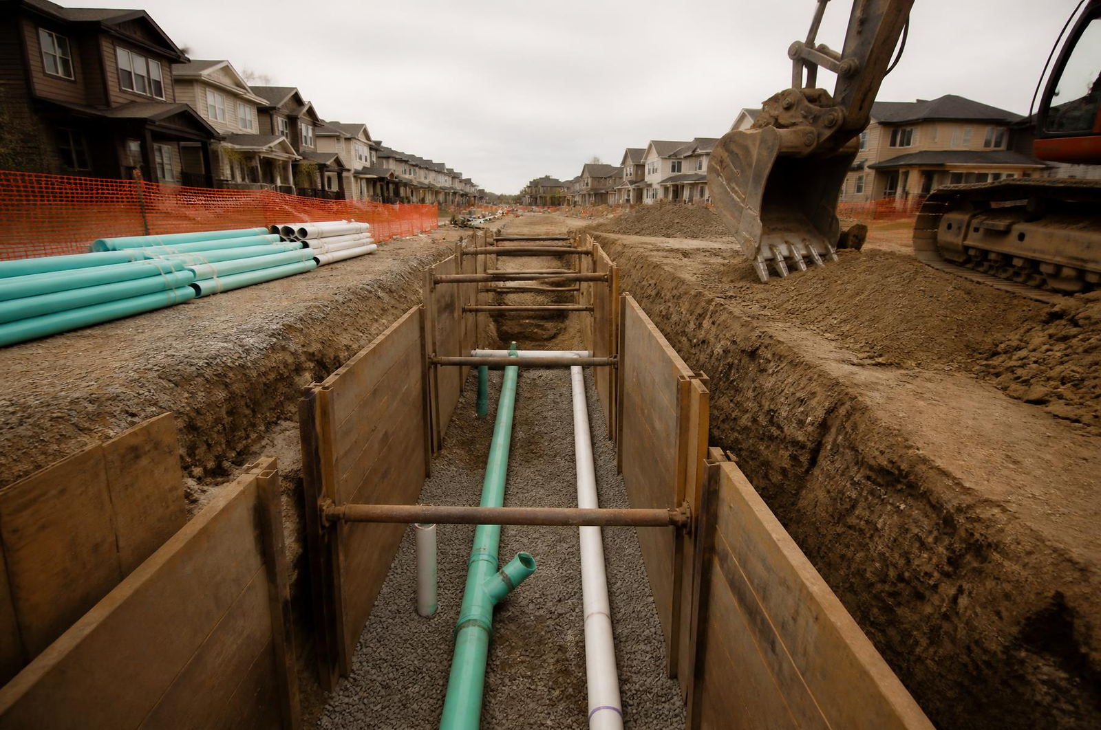 Shored utility trench with new sewer and water main on a Lane Built Inc. development site
