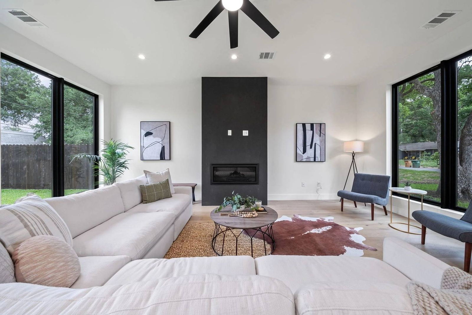 Living room with black plaster fireplace and vaulted ceiling